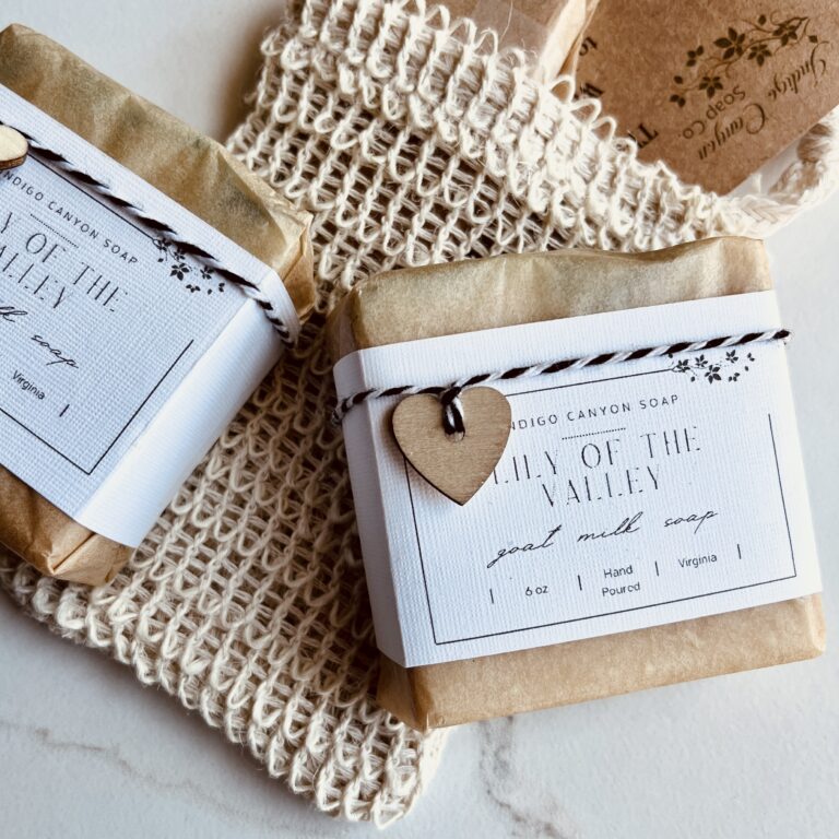 Homemade soaps wrapped and sitting on a soap-saver bag