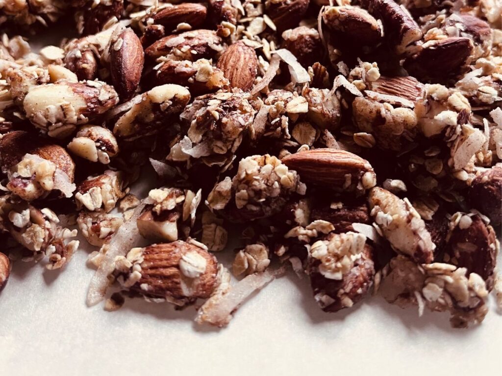 granola spread on a backing sheet