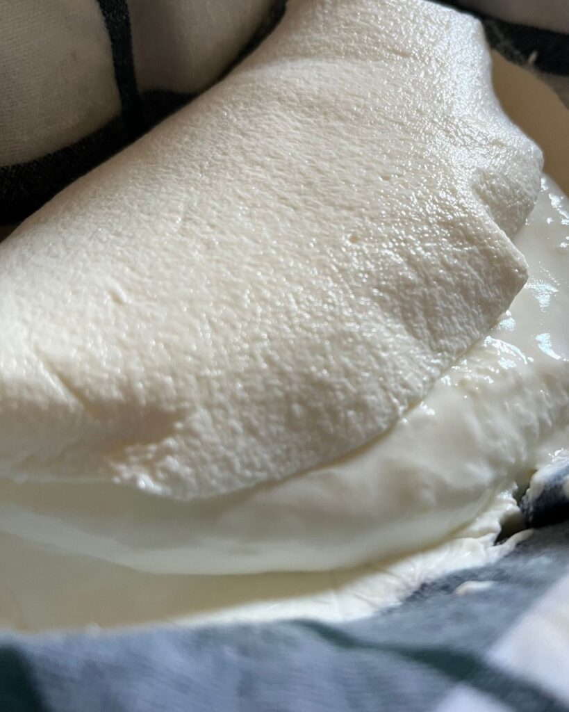 Greek yogurt on a cloth in a strainer