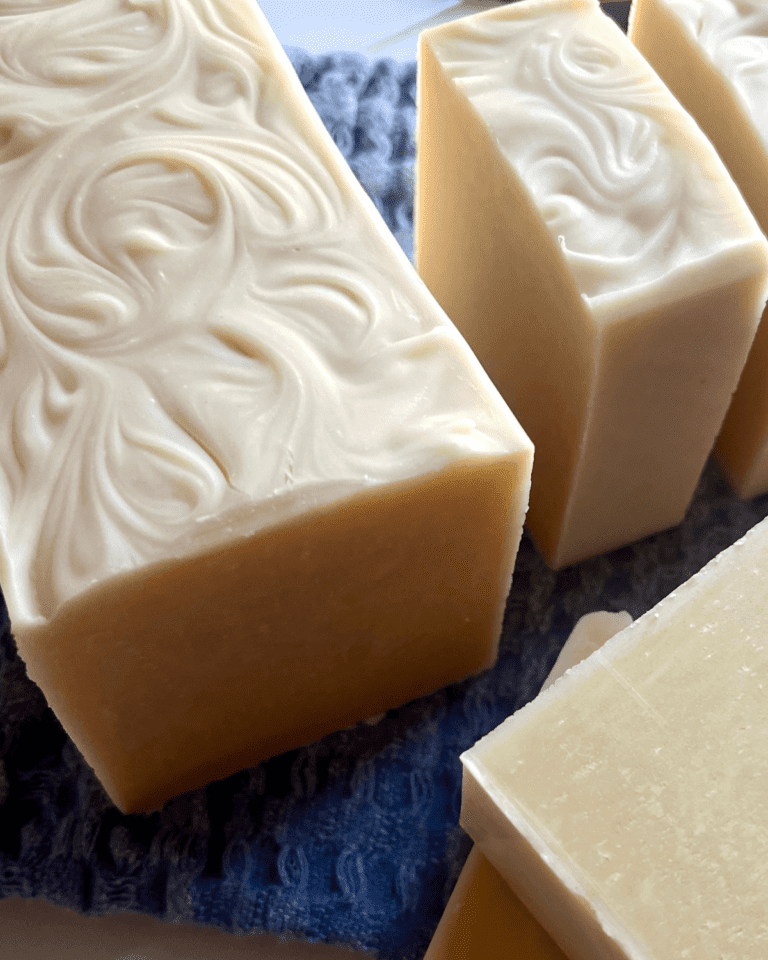 Freshly cut soap bars sitting on a bluecloth