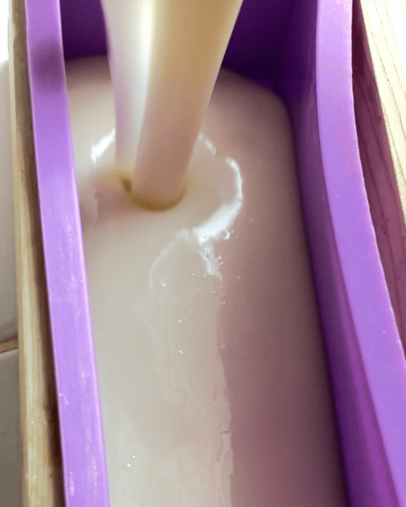 Milk soap being pourend into a mold.