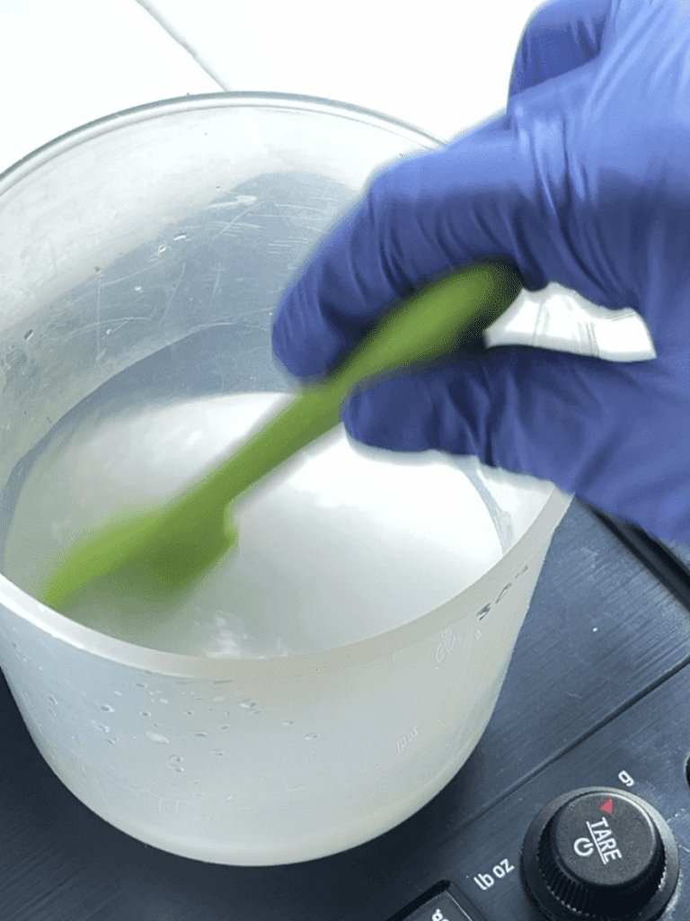 Soapmaking blending lye and water.