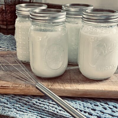 homemade Greek yogurt in canning jars on a cutting board