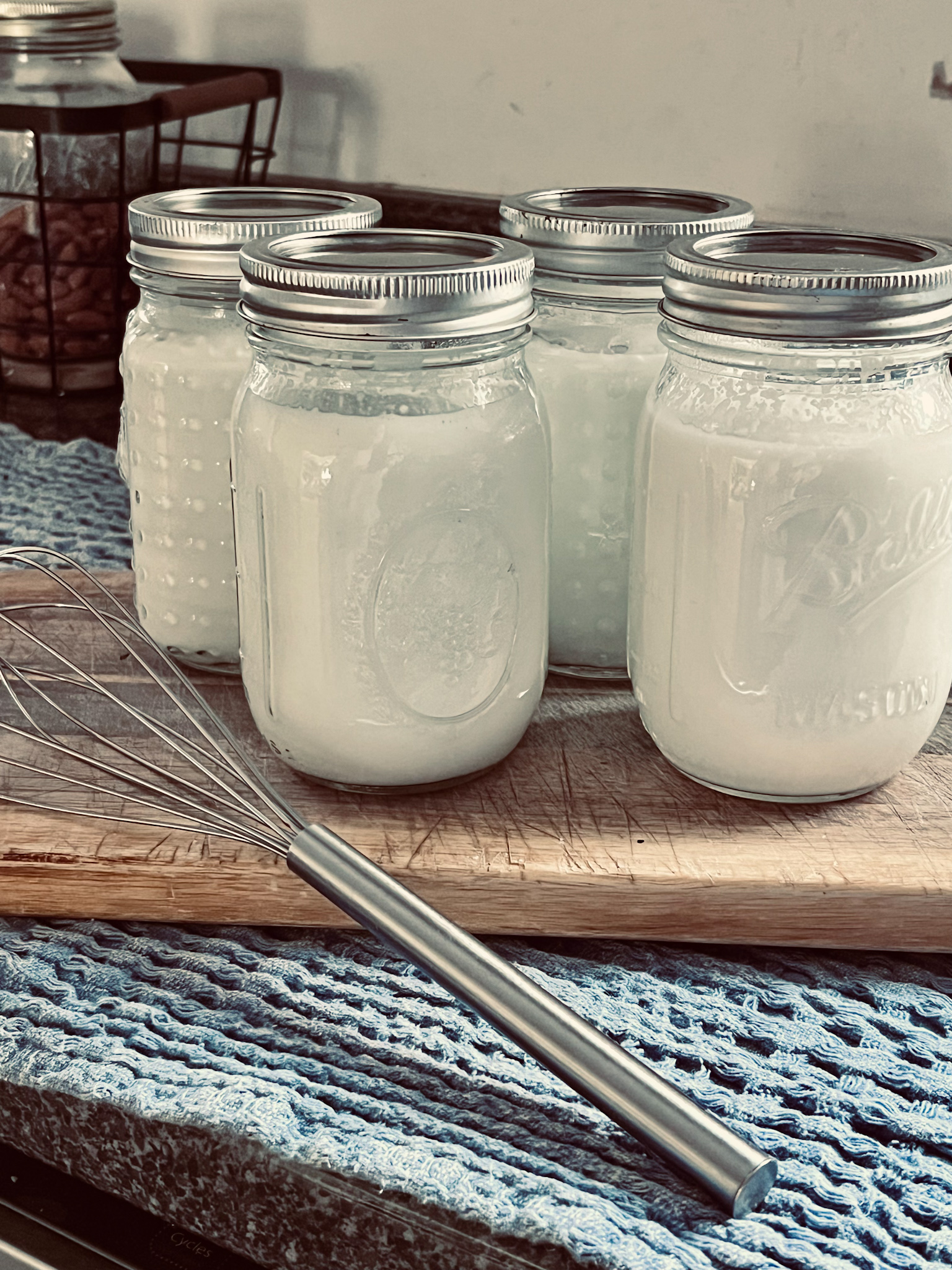 homemade Greek yogurt in canning jars on a cutting board