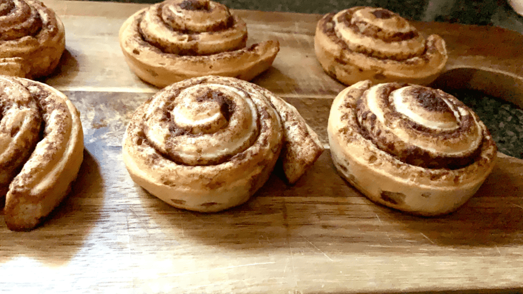 Uniced cinnamon rolls on a cutting board