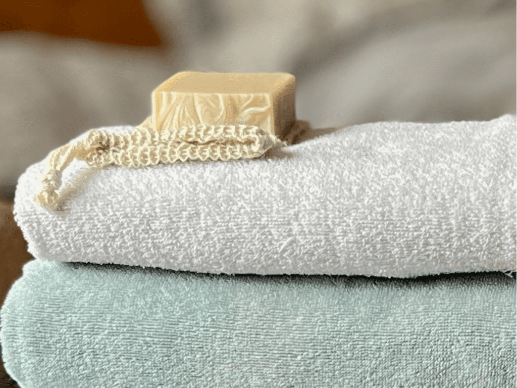 Stack of bath towels with a bar of soap on top