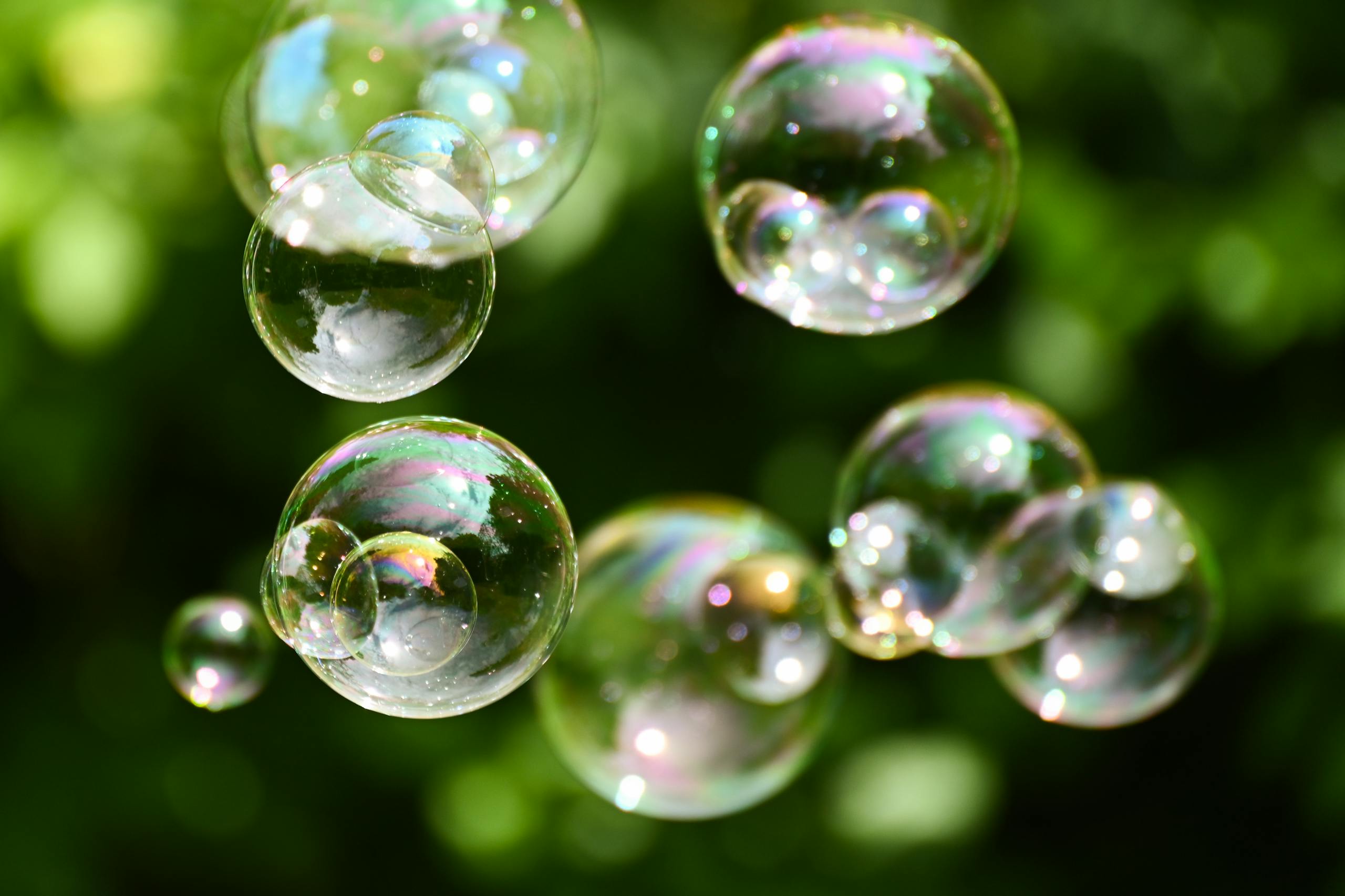 Vibrant soap bubbles floating in a sunlit garden create a playful and dreamy atmosphere.