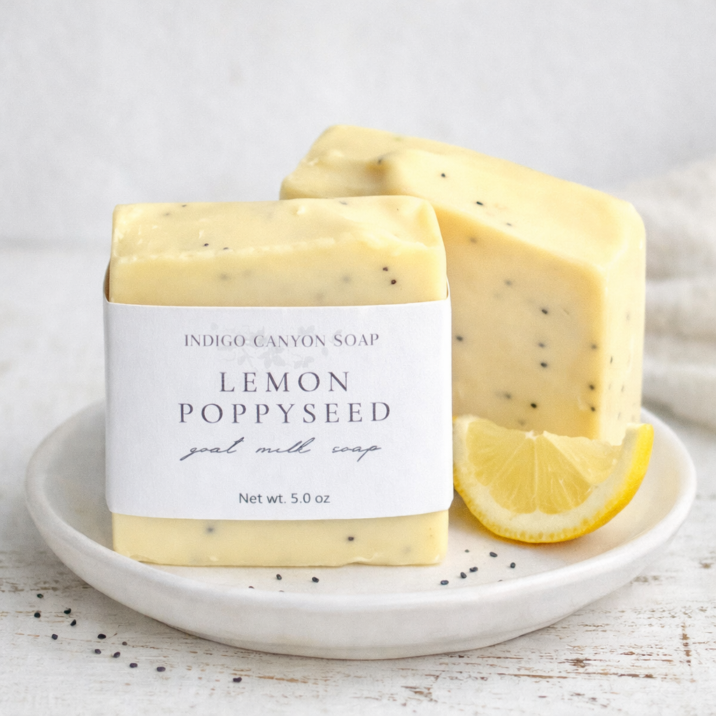 Lemon Poppyseed goat milk soap bar in a ceramic dish.